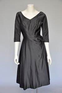 1950s black satin party dress with side bow XS