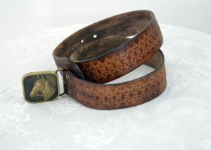 1970s tooled leather belt and BTS horse heard brass buckle size L - Fashionconstellate.com