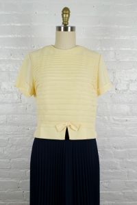 1950s pastel yellow nylon blouse . pleated 50s back button boxy top . medium